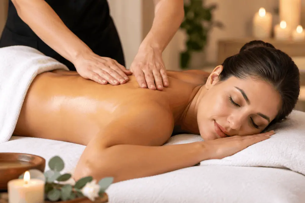 A client receiving a relaxing Swedish spa massage in a warm, candlelit setting in South Elgin, IL